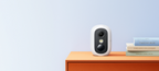 White eufyCam C35 placed on an indoor shelf; manufacturer placement illustration