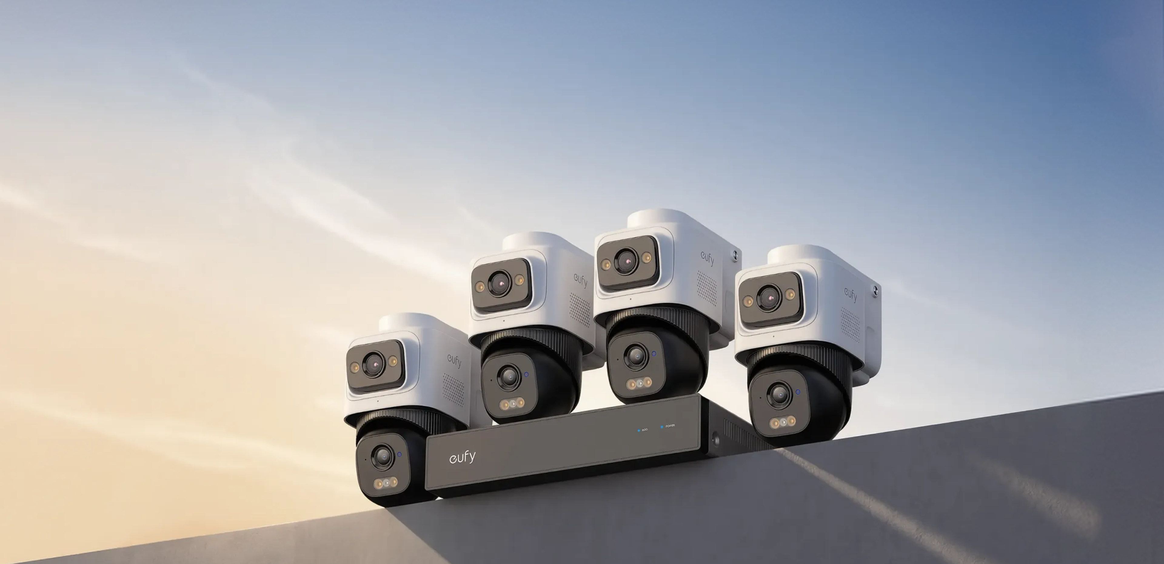 eufy NVR Security System E50, with four dual-lens cameras and a local network recorder, in the official sunset product photograph