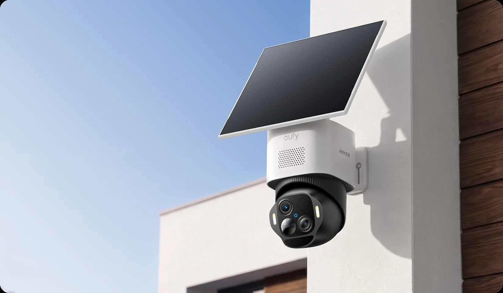 SoloCam E50 with its solar panel, mounted on the side of a house
